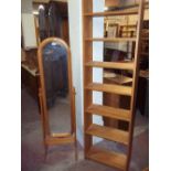 A PINE CHEVAL FLOOR STANDING MIRROR AND A NARROW SOLID PINE BOOKCASE (2)