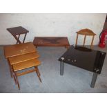 A TEAK NEST OF THREE TABLES, A FOLDING TABLE, A MAHOGANY CARVED TABLE ETC. (5)
