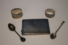 A SILVER CIGARETTE CASE, TWO SPOONS AND TWO NAPKIN RINGS