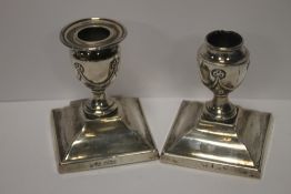 A PAIR OF WEIGHTED SILVER DWARF CANDLESTICKS