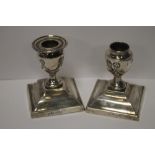 A PAIR OF WEIGHTED SILVER DWARF CANDLESTICKS