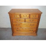 A SOLID PINE CHEST OF DRAWERS WITH SEVEN DRAWERS