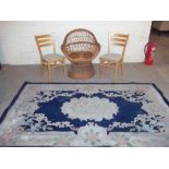 A WICKER EASY CHAIR, TWO MODERN KITCHEN CHAIRS AND AN ORIENTAL RUG (4)