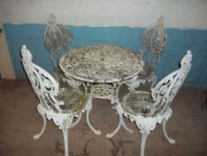 AN ALUMINIUM ROUND GARDEN TABLE AND FOUR CHAIRS