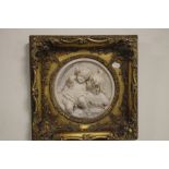 A GILT FRAMED MARBLE EFFECT SCULPTURE