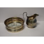 A HALLMARKED SILVER CREAM JUG AND A HALLMARKED WINE COASTER