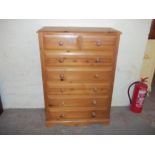 A SOLID PINE CHEST OF DRAWERS WITH TWO OVER THREE DRAWERS