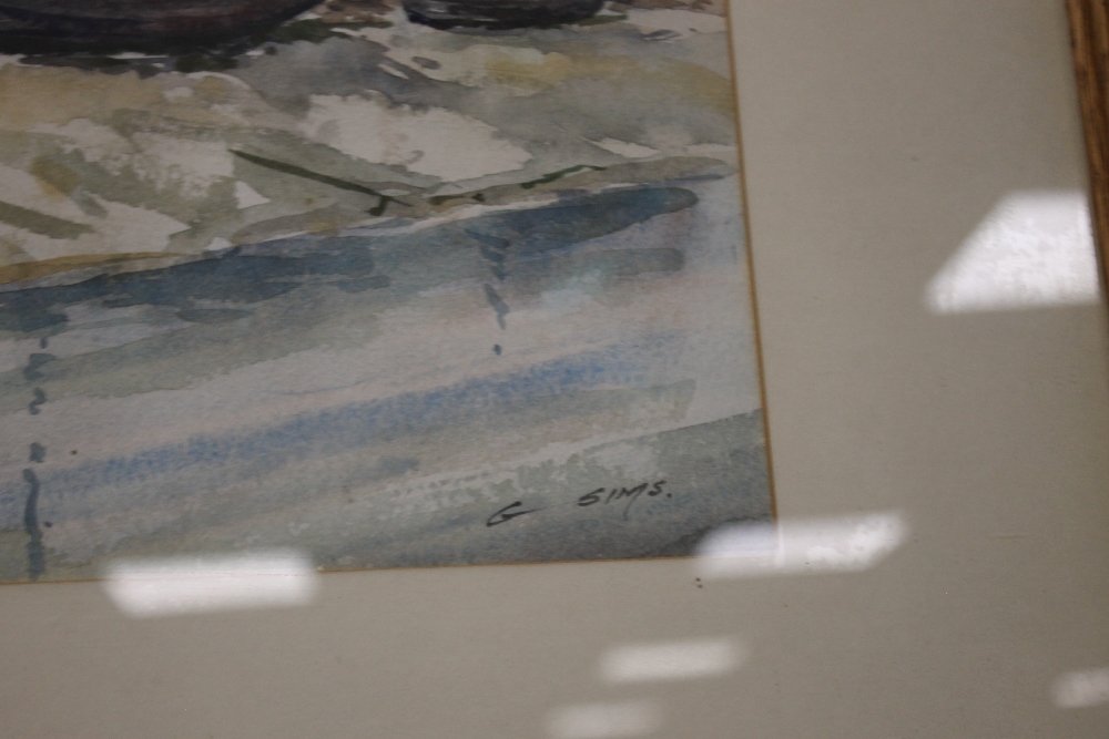 A FRAMED AND GLAZED WATERCOLOUR DEPICTING BOATS ON THE EDGE OF A VILLAGE SIGNED TO THE LOWER - Image 2 of 3