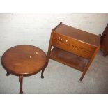 A LOW ROUND COFFEE TABLE AND AN OAK SERVING TROLLEY