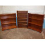 THREE LOW BOOKCASES, TWO IN YEW REPRODUCTION AND ONE IN TEAK