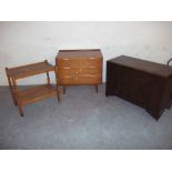 A TEAK THREE DRAWER CHEST OF DRAWERS, A BLANKET CHEST AND A WOODEN SERVING TEA TROLLEY