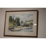 A FRAMED AND GLAZED WATERCOLOUR DEPICTING BOATS ON THE EDGE OF A VILLAGE SIGNED TO THE LOWER