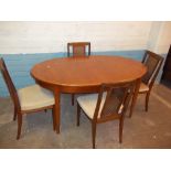 A TEAK EXTENDING DINING TABLE AND FOUR RATTAN BACKED CHAIRS