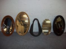 FOUR OVAL WALL MIRRORS AND A HORSE COLLAR