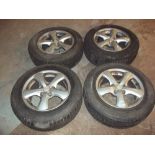 FOUR ALLOY WHEELS AND FIVE TYRES