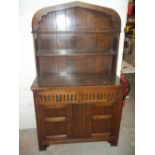 AN OAK GOTHIC STYLE DRESSER WITH LINEN FOLD DETAIL