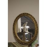 A GILT FRAMED OVAL MIRROR 22 CM X 18 CM