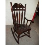 A SOLID HEAVY CHUNKY ROCKING CHAIR