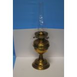 A PARAFFIN LAMP WITH GLASS FLUTE