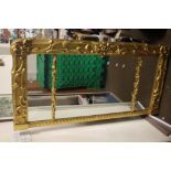 A LARGE GILT FRAMED MIRROR 56 CM X 28 CM