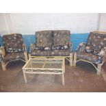 A FOUR PIECE BAMBOO CANE CONSERVATORY SUITE, TWO SEATER SOFA, TABLE AND TWO CHAIRS A/F