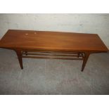 A RETRO TEAK COFFEE TABLE IN LONG JOHN STYLE WITH STRETCHER SHELF