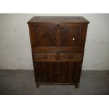 AN OAK DRINKS CABINET WITH CARVED DETAIL A/F