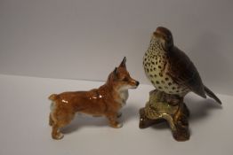 A BESWICK THRUSH AND A DOULTON DOG