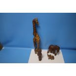 A COLLECTION OF CARVED AFRICAN ANIMALS TO INCLUDE A GIRAFFE, ELEPHANT AND AN OWL