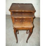 A BURR WALNUT NEST OF THREE TABLES WITH CABRIOLE STYLE LEGS