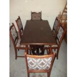 A DARK OAK DINING TABLE AND SIX CHAIRS INCLUDING TWO CARVERS