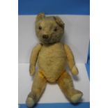 A VINTAGE JOINTED TEDDY BEAR, in play worn condition