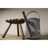 A VINTAGE CARVED OAK MILKING STOOL TOGETHER WITH A WATERING CAN