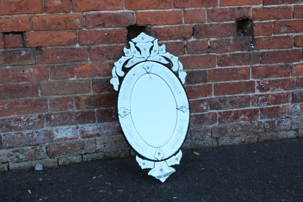 A FLORAL OVAL WALL MIRROR OVERALL SIZE - 77CM X 39CM