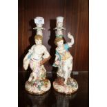 A PAIR OF CONTINENTAL FIGURAL CANDLE STICKS, H 30 CM