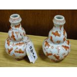 A PAIR OF SMALL ORANGE AND WHITE DOUBLE GOURD ORIENTAL CERAMIC VASES DECORATED WITH BATS WITH ORANGE