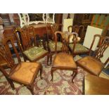 A SET OF SIX ANTIQUE MAHOGANY CARVED DINING CHAIRS WITH TAPESTRY SEATS