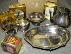 A BOX OF METALWARE TO INCLUDE A SILVER PLATED TEA POT, MODERN CARRIAGE CLOCKS ETC.