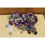 TWO TUBS OF ASSORTED COSTUME JEWELLERY