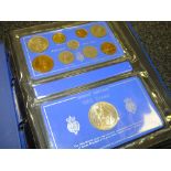 A BRI - LINING DE LUXE COIN ALBUM CONTAINING BRITISH COIN SETS