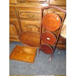 A VINTAGE MAHOGANY DUMB WAITER AND TWO SERVING TRAYS (3)