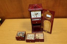 A NOVELTY LONG CASED CLOCK SHAPED JEWELLERY BOX CONTAINING COSTUME JEWELLERY TO INCLUDE CHARM