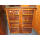 AN OAK GLAZED TWO DOOR BOOKCASE, W 92 cm