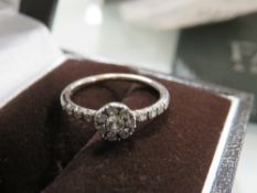 A FAVERO DIAMOND RING RETAILED THROUGH MAPPIN & WEBB, stamped 750, and coming with guarantee stating