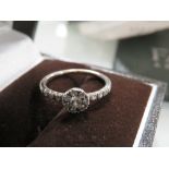 A FAVERO DIAMOND RING RETAILED THROUGH MAPPIN & WEBB, stamped 750, and coming with guarantee stating
