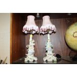 A PAIR OF CONTINENTAL STYLE CERAMIC FIGURAL TABLE LAMPS