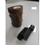 A LEATHER CASED LUMINOS 6X24 MONOCULAR
