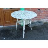 A PAINTED WHITE CAST GARDEN TABLE