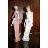 TWO LARGE NAO FIGURES, OF A LADY HOLDING A KITTEN AND A LADY IN A WHITE DRESS