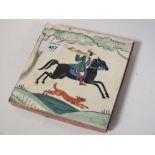 AN ANTIQUE HAND PAINTED PIECED TERRACOTTA TILE DECORATED WITH A HUNTING SCENE